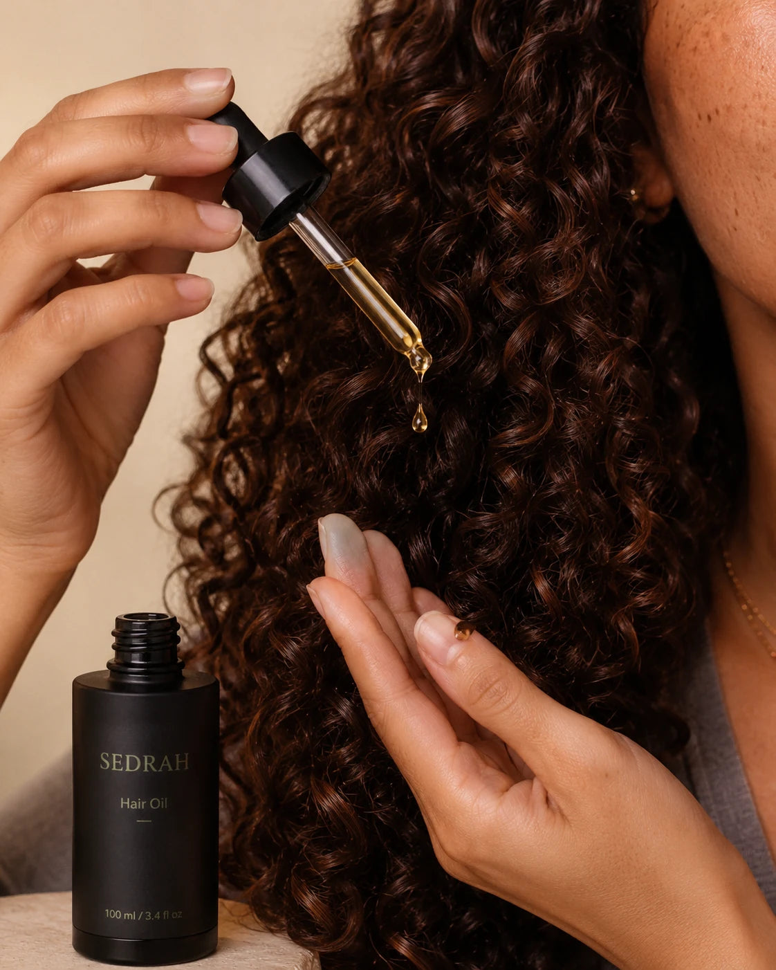 Applying Sedrah Essence Oil to hair — one drop, every strand