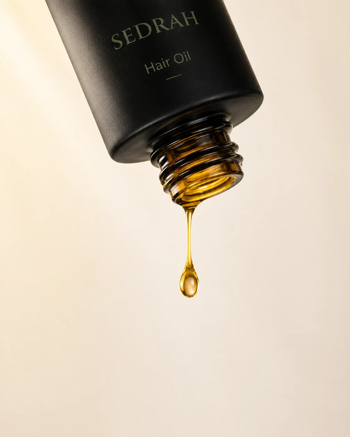 Sedrah Essence Oil drip detail — pure botanical shine